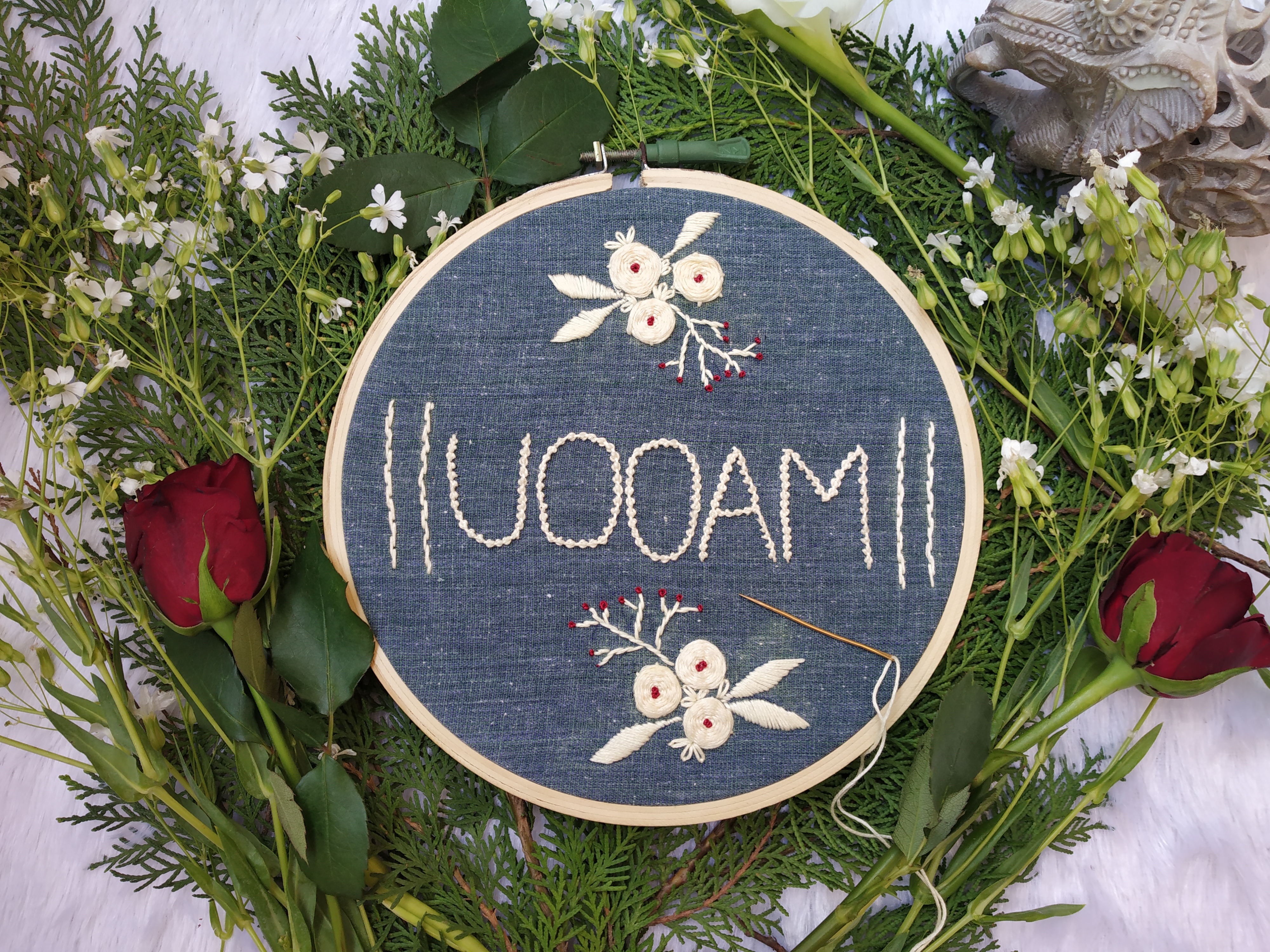 Uooam embroidery surrounded by flowers